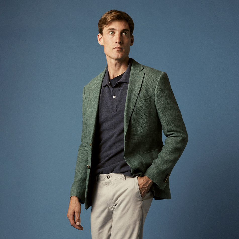 Man in green blazer, dark Rodd and Gunn polo shirt, and light chinos.