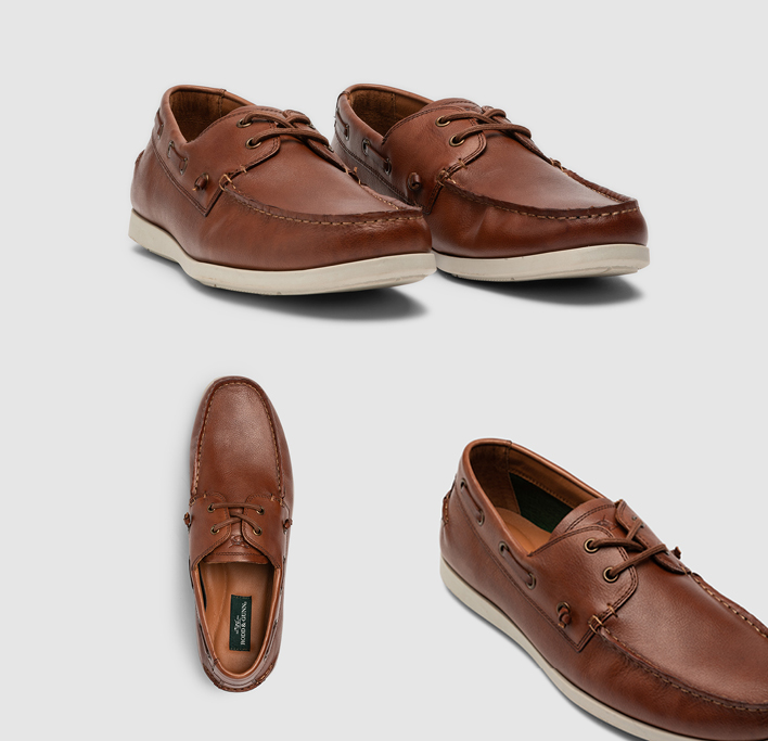 Men's brown leather boat shoes with white sole.