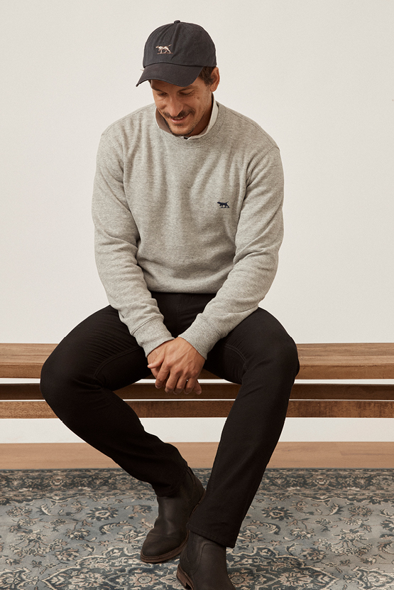 Rodd & Gunn grey jumper, black signature cap and black men's jeans.