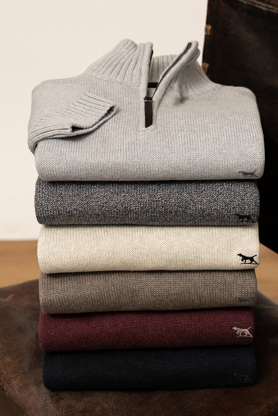 Stack of Rodd & Gunn quarter-zip knitwear.