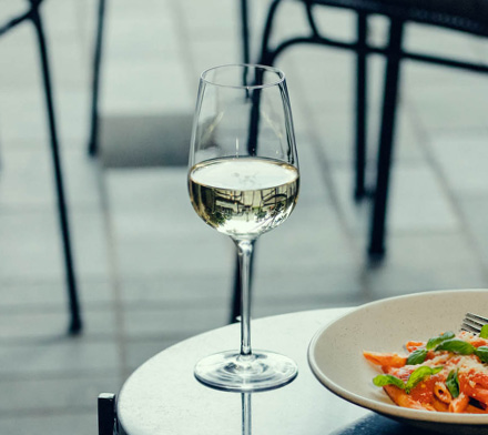 Glass of white wine on a table.