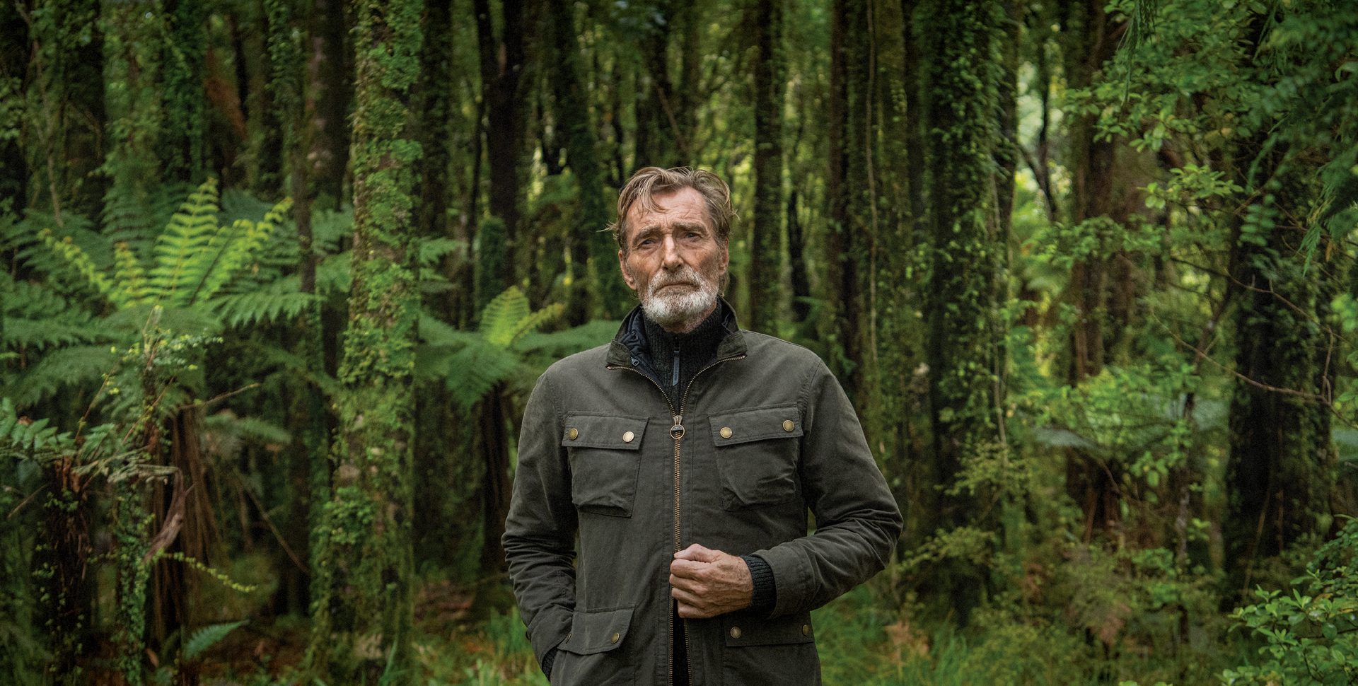 A man leaning on the wall, wearing the Blackpool Easy Fit Jacket and Halls Creek Pants.
