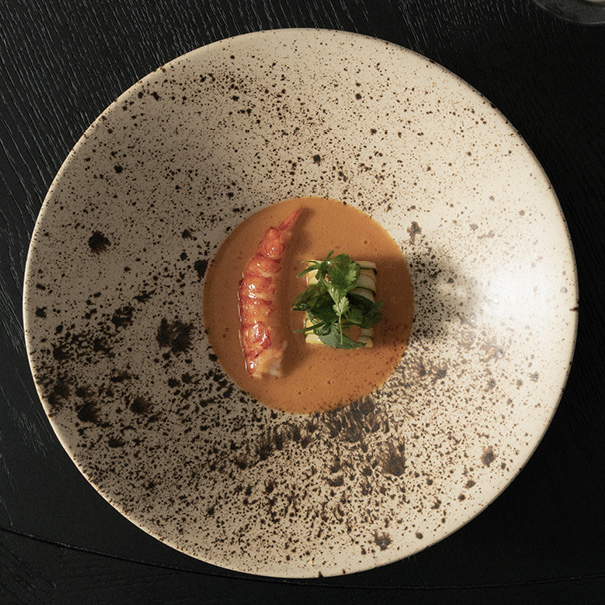 Artfully arranged meal on a clean plate, showcasing fresh ingredients and fine dining presentation.