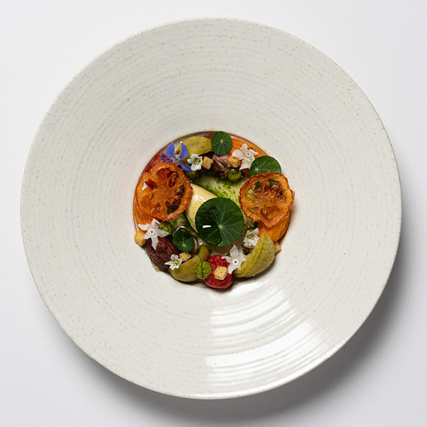 A beautifully plated gourmet dish with vibrant colors and elegant presentation.